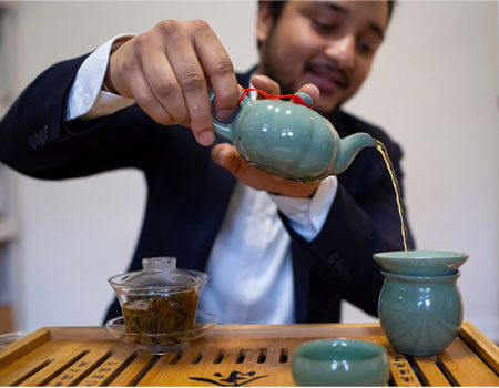 Nishchal Banksota preparing a tea from his company, Nepal Tea, at his home in Woodside, Queens.CreditNicole Craine for The New York Times