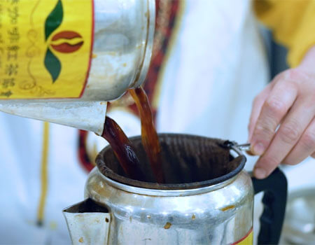 The tea bag is boiled in a tall tea pot, strained multiple times and then combined with a dollop of evaporated milk. Photo: Goldthread