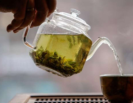 The owner of a tea house pours a cup of tea in this picture illustration taken April 25, 2020. (Reuters)