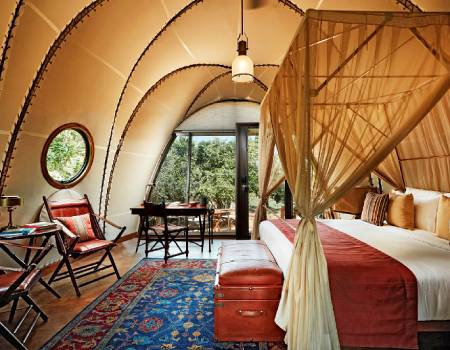 Cocoon suites come complete with panoramic jungle views, four-poster beds and rustic furnishings.