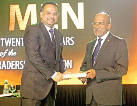 Chairman CTTA Anselm Perera, hands over the anniversary publication ‘Tea Men’ to Minister Dissanayake at the Shangri-La Hotel in Colombo on Friday. Picture by Chaminda Niroshan
