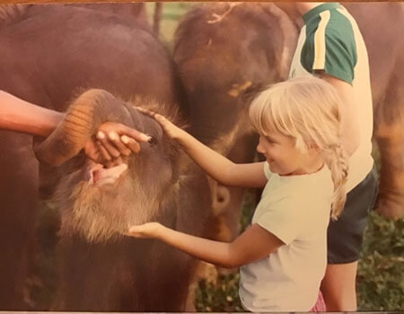 Six-year old me with orphan elephants when we lived in Sri Lanka.
