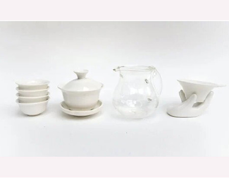 From left to right: traditional Chinese tea cups, a gaiwan, the fairness pitcher and a porcelain strainer.