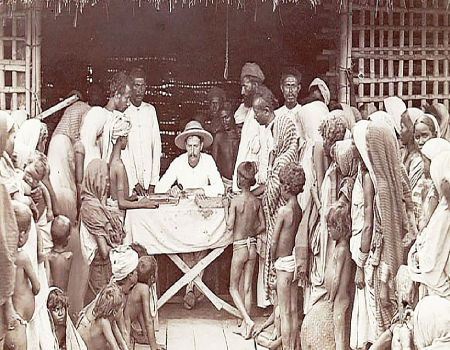 In another 1903 photograph, we see a scene depicting the payment of wages to workers by a European manager. (Photo credit: Bourne and Shepherd Studio, Calcutta)