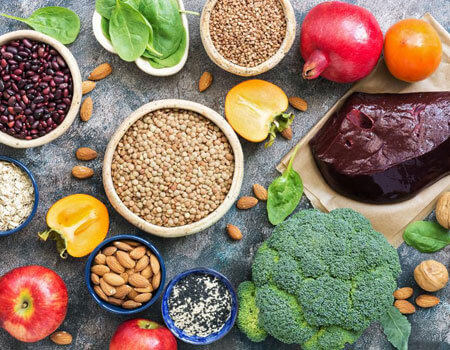 These foods are among those high in iron: Liver, broccoli, persimmon, apples, nuts, legumes spinach